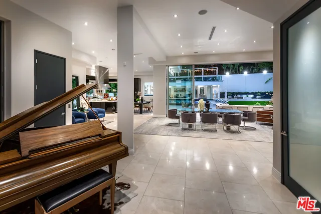 a living room filled with furniture potted plant and a large window