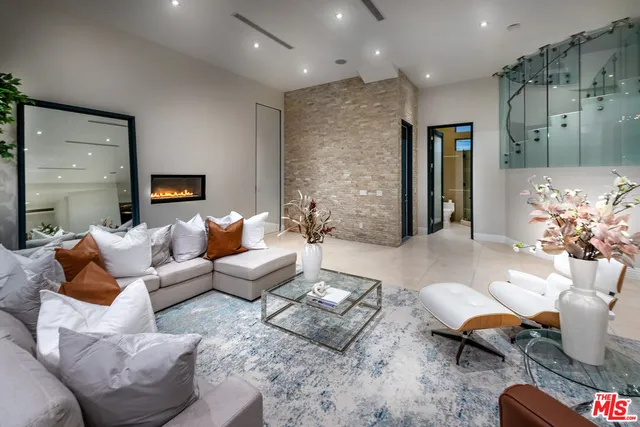a kitchen with a dining table cabinets and living room view