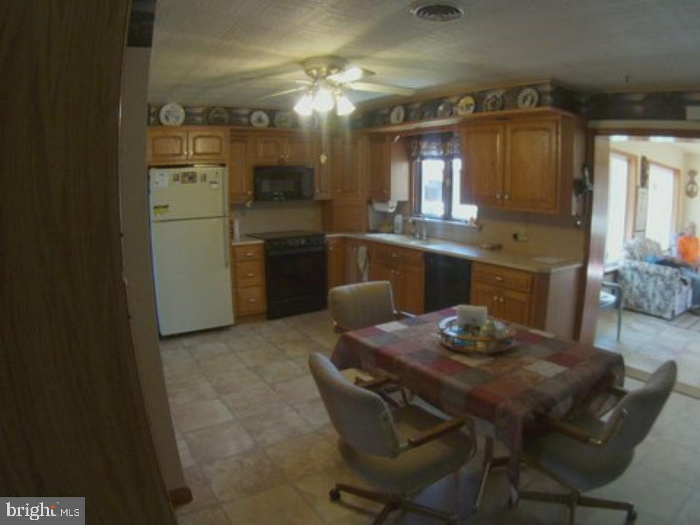41 Cocalico Road Robesonia, PA 19551 - Photo 2 of 16 a kitchen with a table chairs refrigerator and cabinets