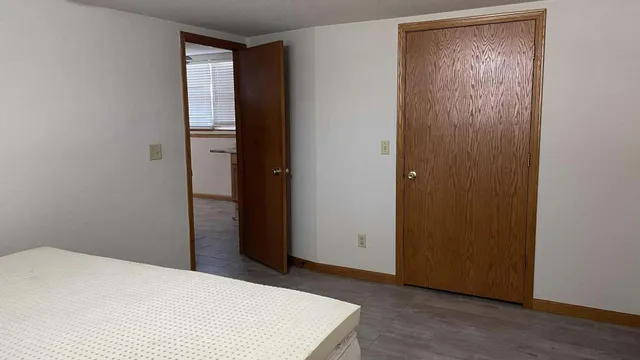 a white toilet sitting next to a bath tub