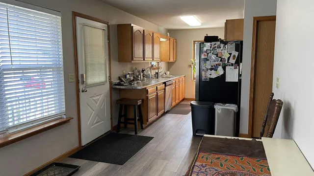a view of a kitchen with refrigerator and cabinets