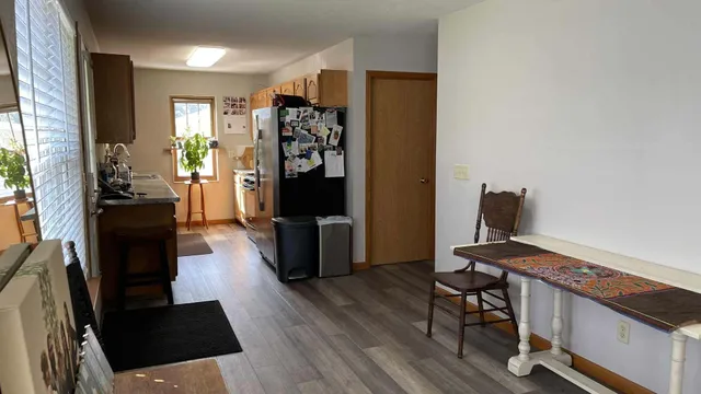 a view of a workspace with furniture and a window