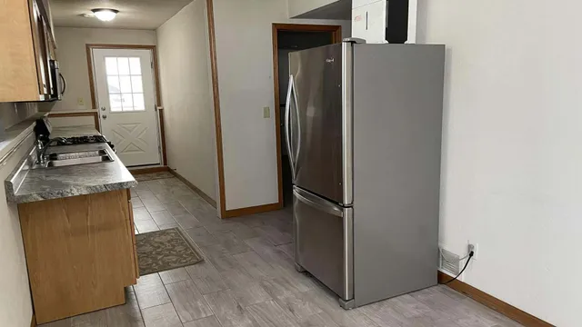 a kitchen with a refrigerator and a stove