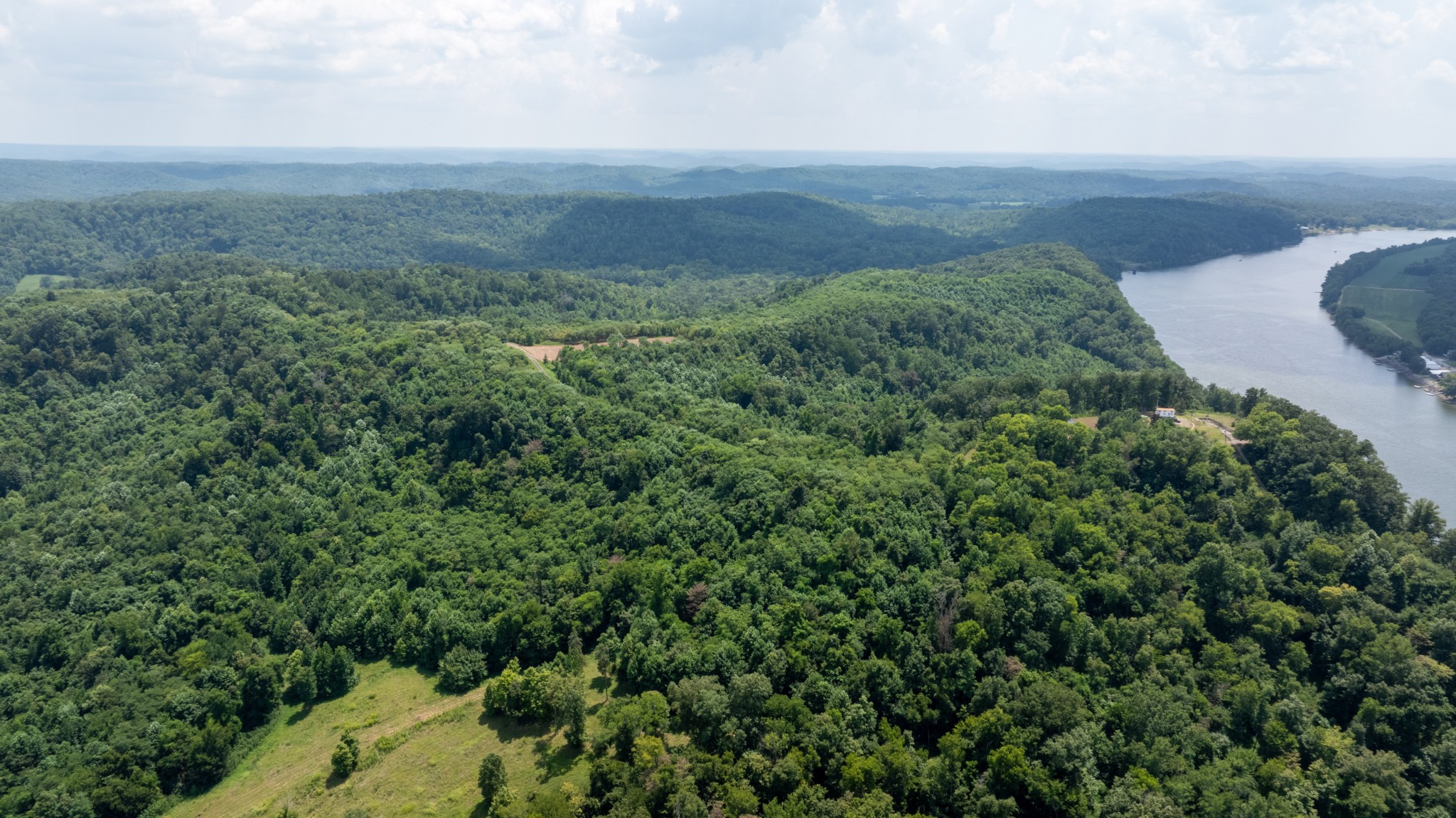 555 New Era Bluff Road Linden, TN 37096 - Photo 21 of 64 a view of a field of grass and trees