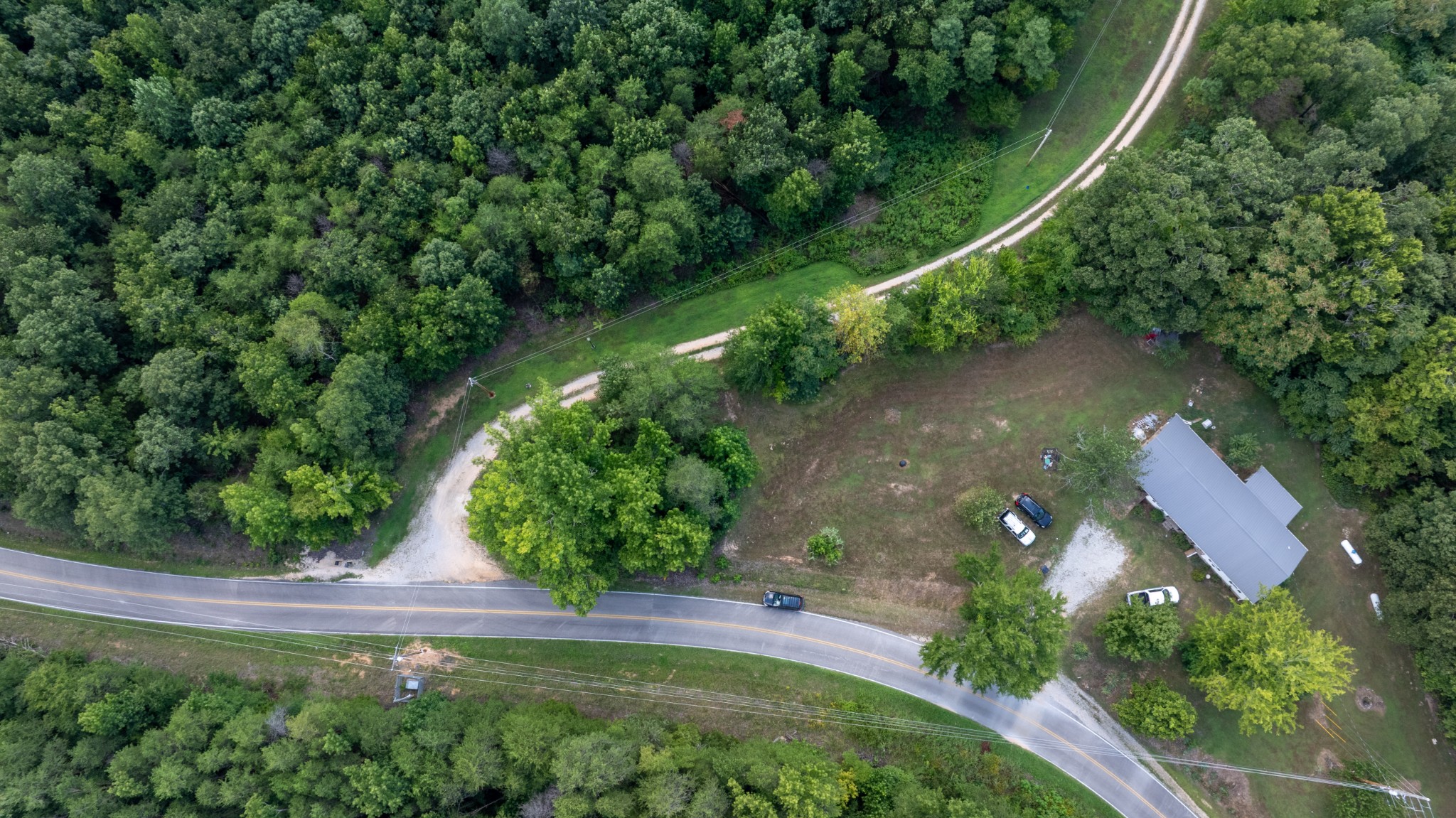 555 New Era Bluff Road Linden, TN 37096 - Photo 56 of 64 an aerial view of a residential houses with outdoor space and trees all around
