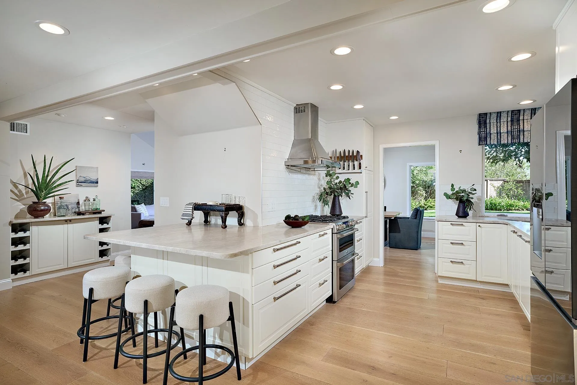 1229 Swallowtail Court Encinitas, CA 92024 - Photo 13 of 36 a kitchen with white cabinets and stainless steel appliances