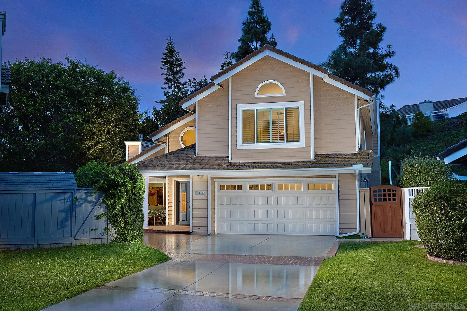1229 Swallowtail Court Encinitas, CA 92024 - Photo 35 of 36 a front view of a house with a yard and garage