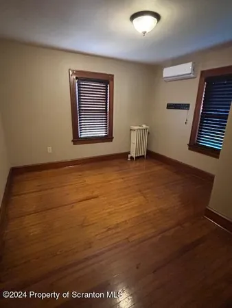 a large bed sitting in a bedroom next to a window