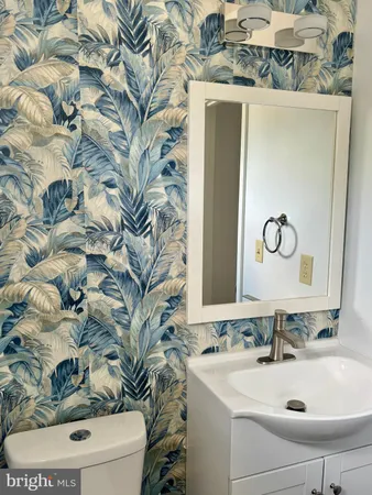 a bathroom with a sink and mirror with toilet
