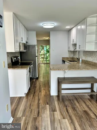 a kitchen with stainless steel appliances a refrigerator sink and cabinets