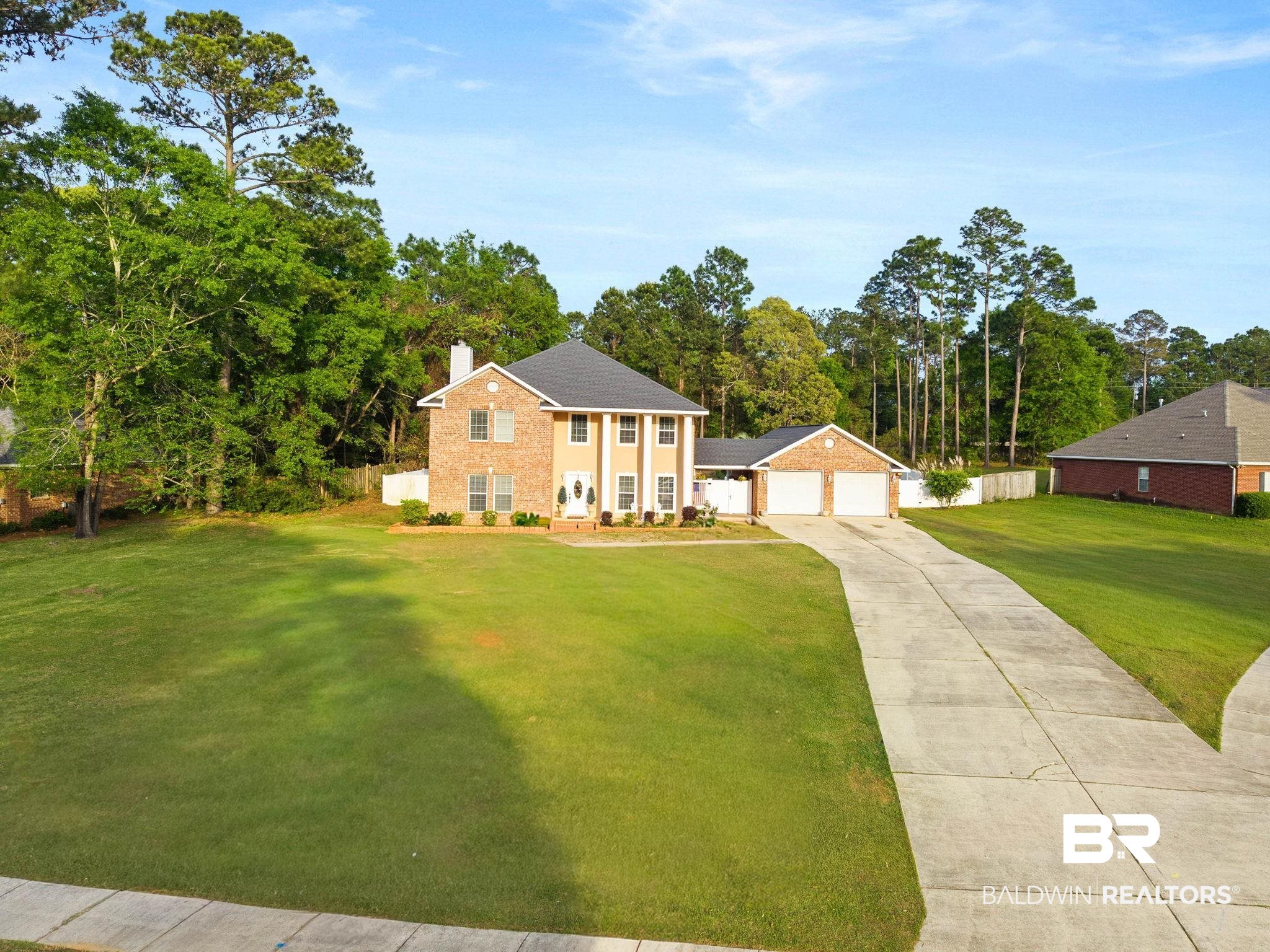 2 Speckle Trout Route Daphne, AL 36527 - Photo 7 of 61 View of front facade featuring a chimney, driveway, and view of wooded area