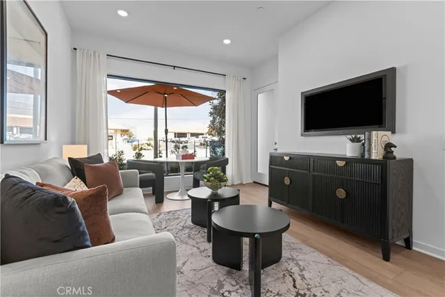 a kitchen with stainless steel appliances kitchen island granite countertop a table chairs microwave and cabinets