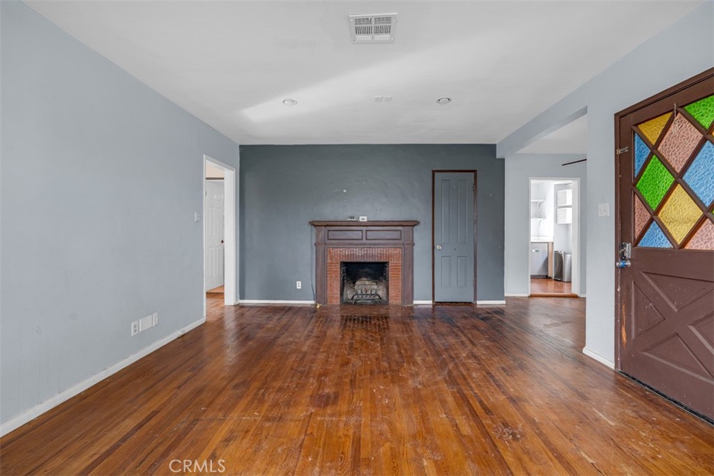 1625 North Maple Street Burbank, CA 91505 - Photo 6 of 30 a view of an empty room with a fireplace and a window