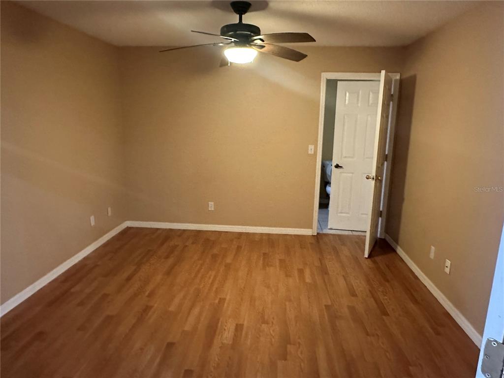 1105 Hill Mount Drive Minneola, FL 34715 - Photo 10 of 12 wooden floor in an empty room with a window