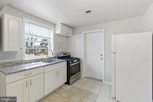 a kitchen with a sink and a stove