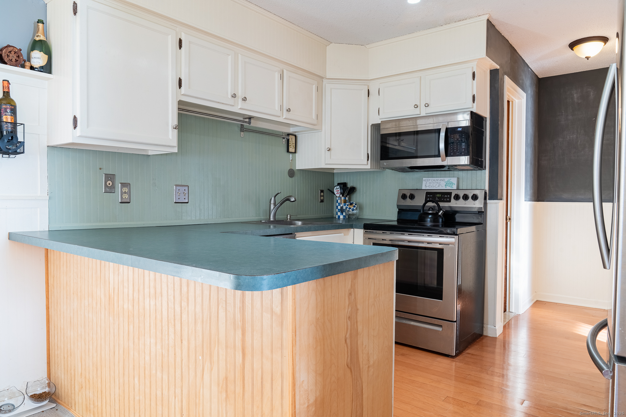 238 Shagbark Drive, Unit 238 Derby, CT 06418 - Photo 9 of 25 a kitchen with stainless steel appliances granite countertop a stove a sink and a refrigerator