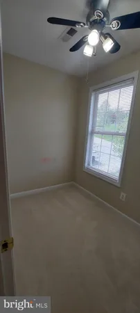 a room with a sink cabinets and window