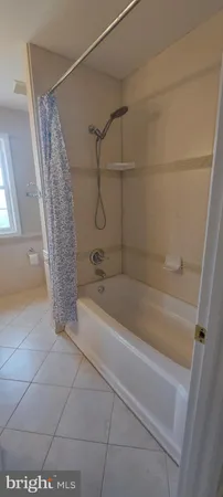 a bathroom with a double vanity sink a mirror and shower