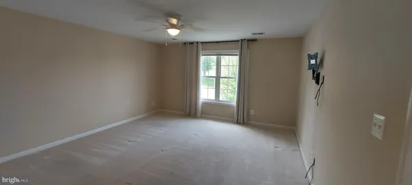 a view of an empty room with windows