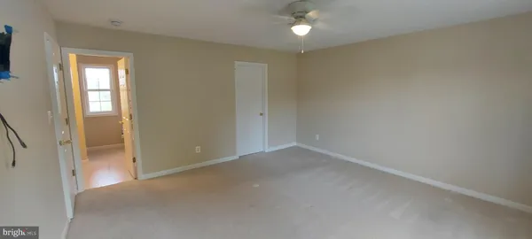 a view of a hallway with furniture and a window