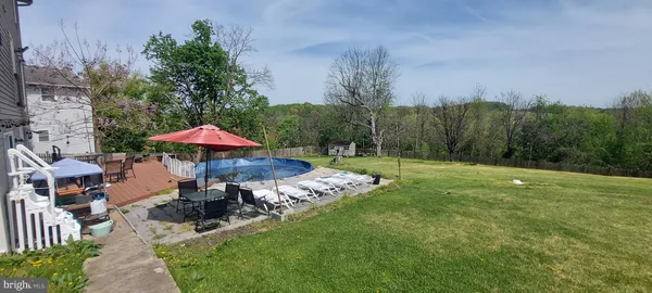 a front view of a house with yard and patio