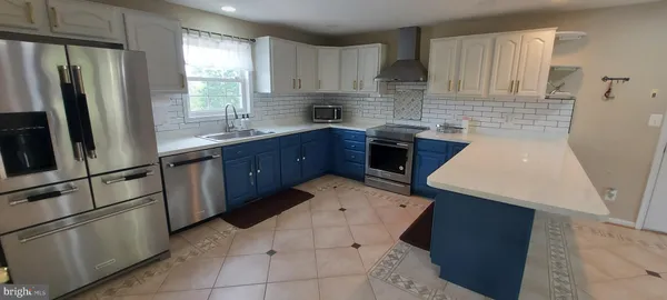 a kitchen with stainless steel appliances granite countertop a refrigerator sink and cabinets
