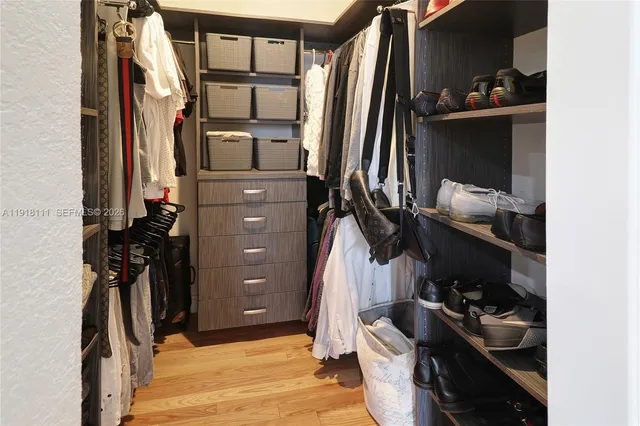 a bathroom with a sink a toilet a mirror and shower