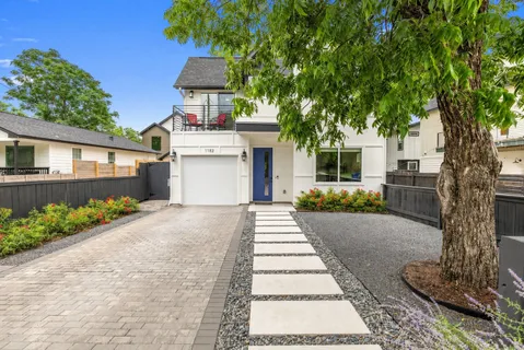 a front view of a house with a garden