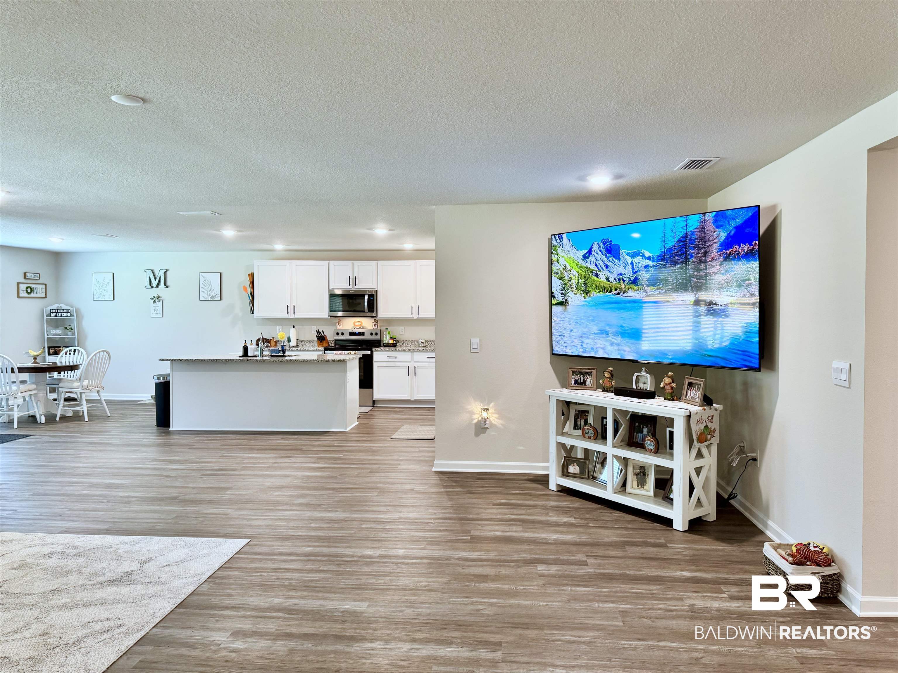 24216 Ringneck Loop Elberta, AL 36530 - Photo 20 of 23 Living area with light wood-type flooring and a textured ceiling