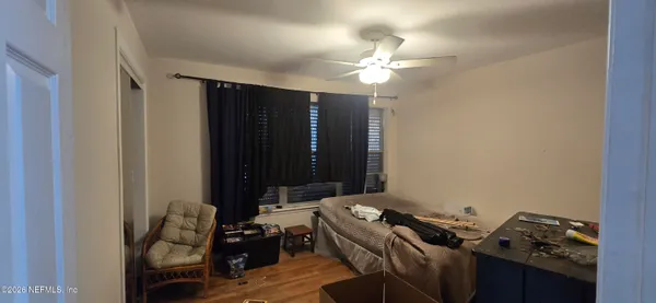 a bedroom with a bed and a mirror