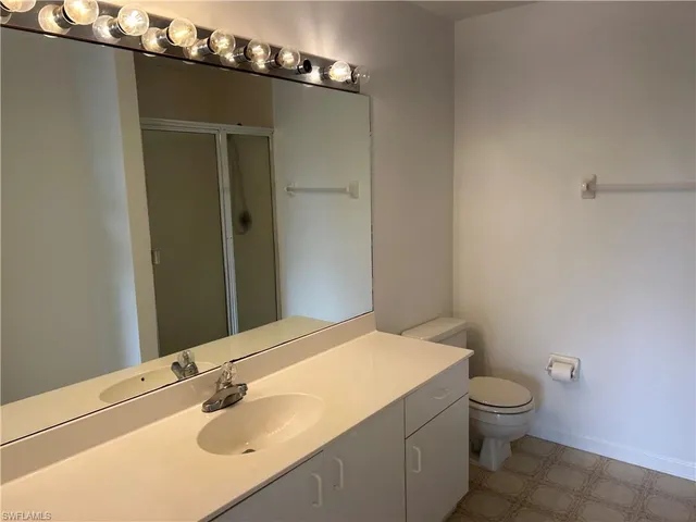 a bathroom with a sink a toilet and mirror