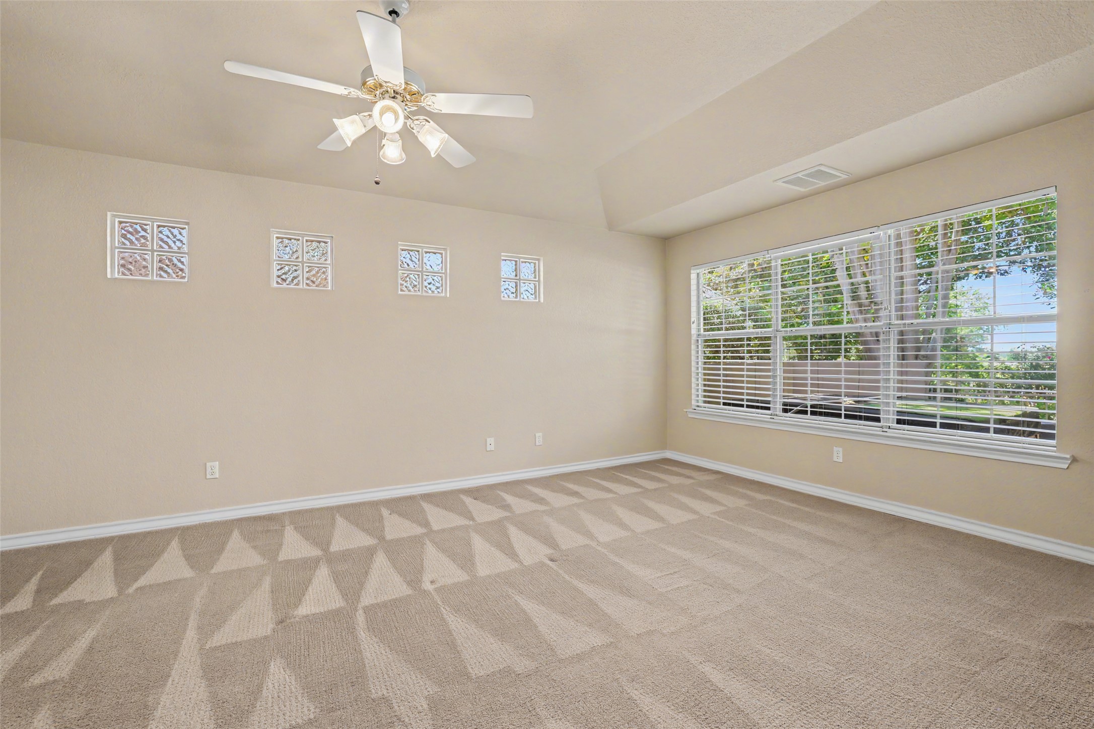 30107 Hamlet Circle Georgetown, TX 78628 - Photo 15 of 40 An airy bedroom with a tray ceiling offers a cozy, well-lit sanctuary.