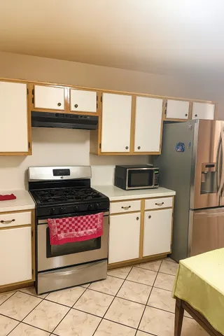 a kitchen with a stove and a cabinets