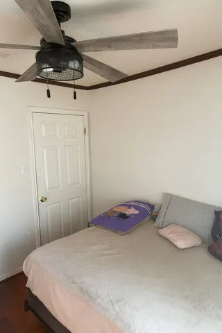 a bedroom with a bed and a chandelier