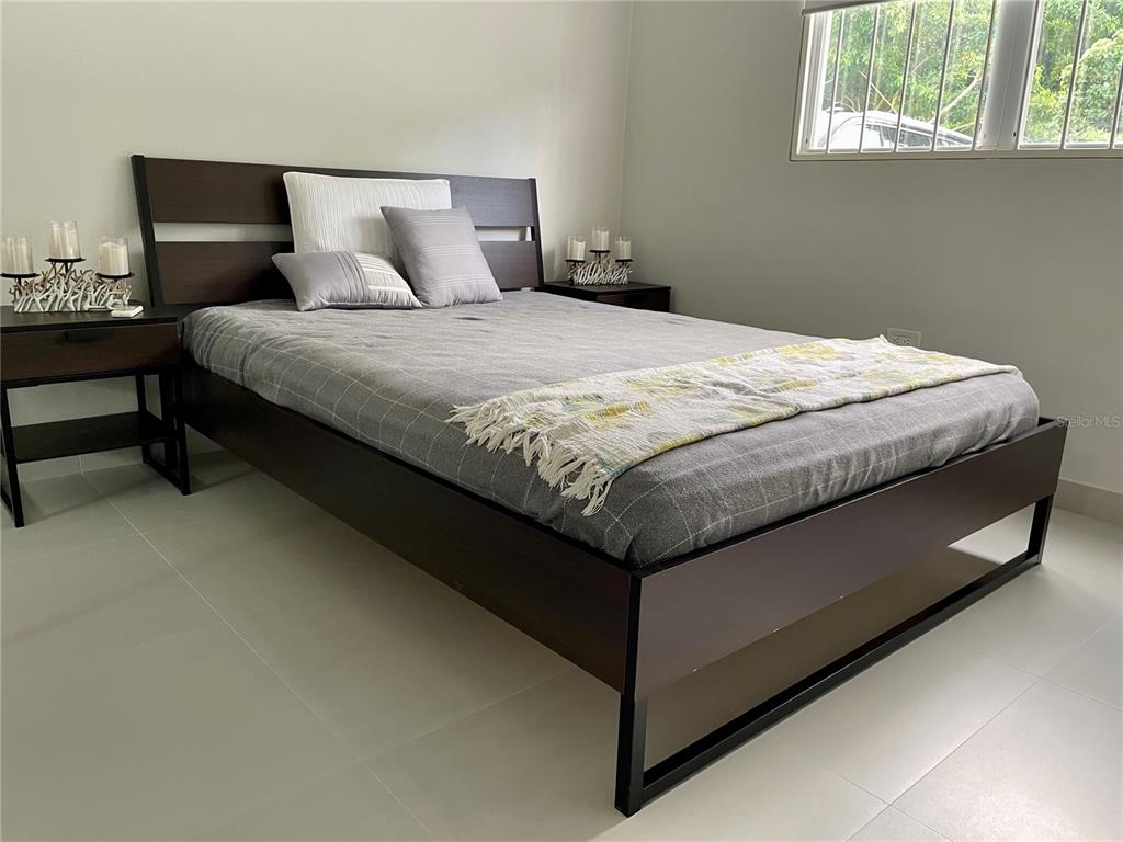 290 Av. Sta. Ana Guaynabo, Bayamón 00969 - Photo 15 of 23 a bed sitting in a bedroom next to a window