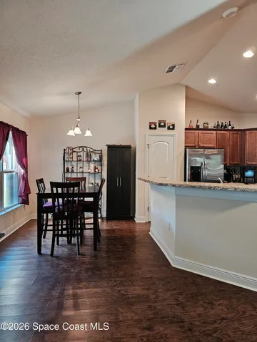 a living room with stainless steel appliances kitchen island granite countertop furniture and a kitchen view