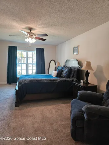 a view of a hallway with a livingroom and a bathroom
