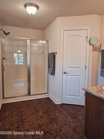 a bathroom with a glass shower door