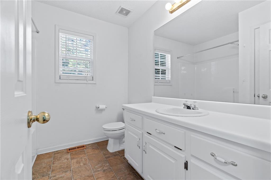 204 Red Fox Court Canton, GA 30114 - Photo 31 of 51 a bathroom with a granite countertop toilet sink and mirror
