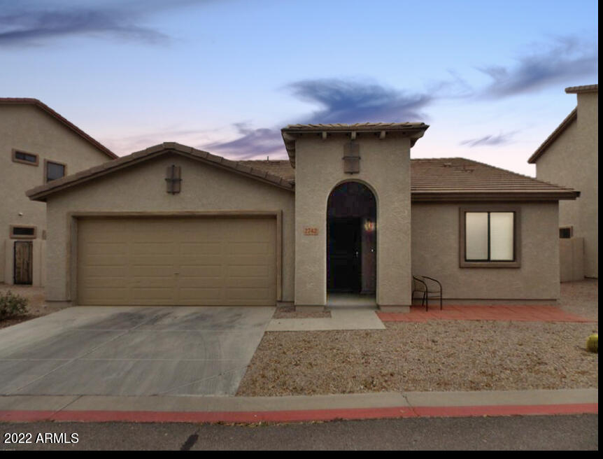 2742 South Powell Road Apache Junction, AZ 85119 - Photo 1 of 34 a front view of a house with garden