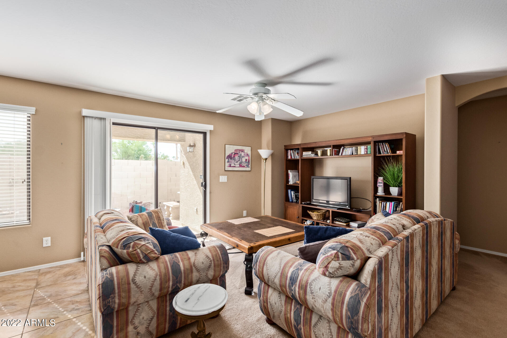 2742 South Powell Road Apache Junction, AZ 85119 - Photo 11 of 34 a living room with furniture a flat screen tv and a large window