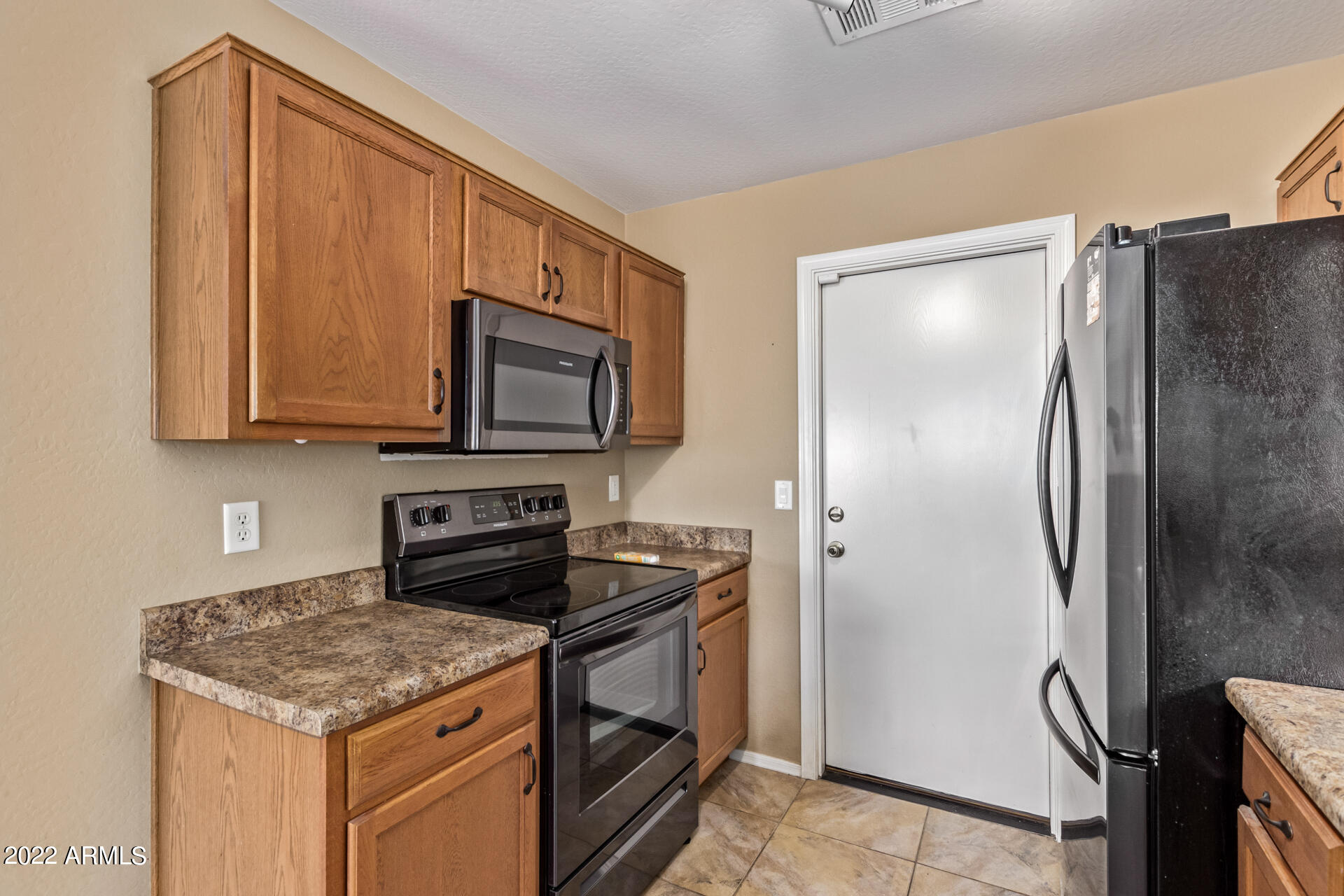 2742 South Powell Road Apache Junction, AZ 85119 - Photo 16 of 34 a kitchen with stainless steel appliances granite countertop a refrigerator stove and microwave