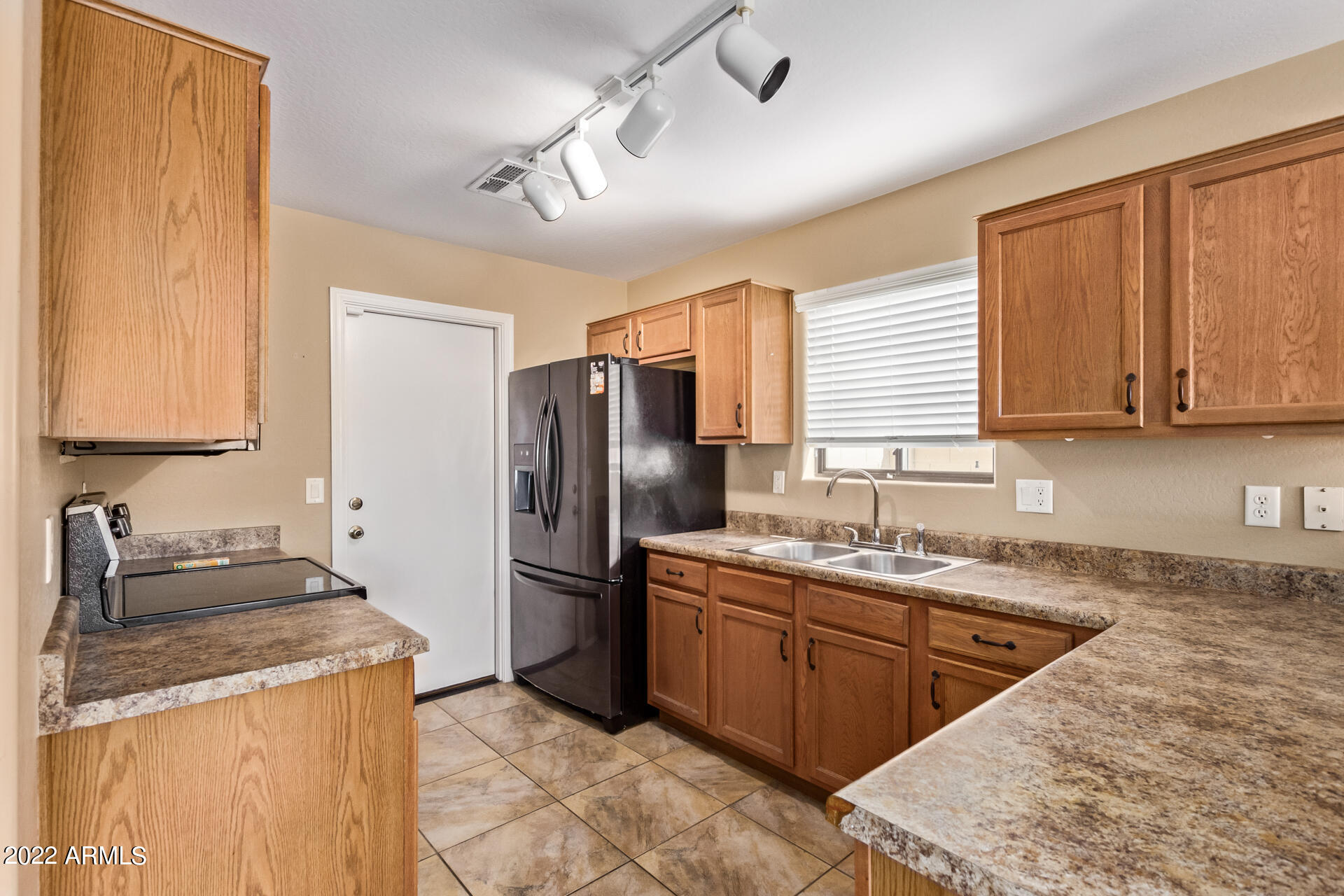 2742 South Powell Road Apache Junction, AZ 85119 - Photo 17 of 34 a kitchen with stainless steel appliances granite countertop a sink stove and refrigerator
