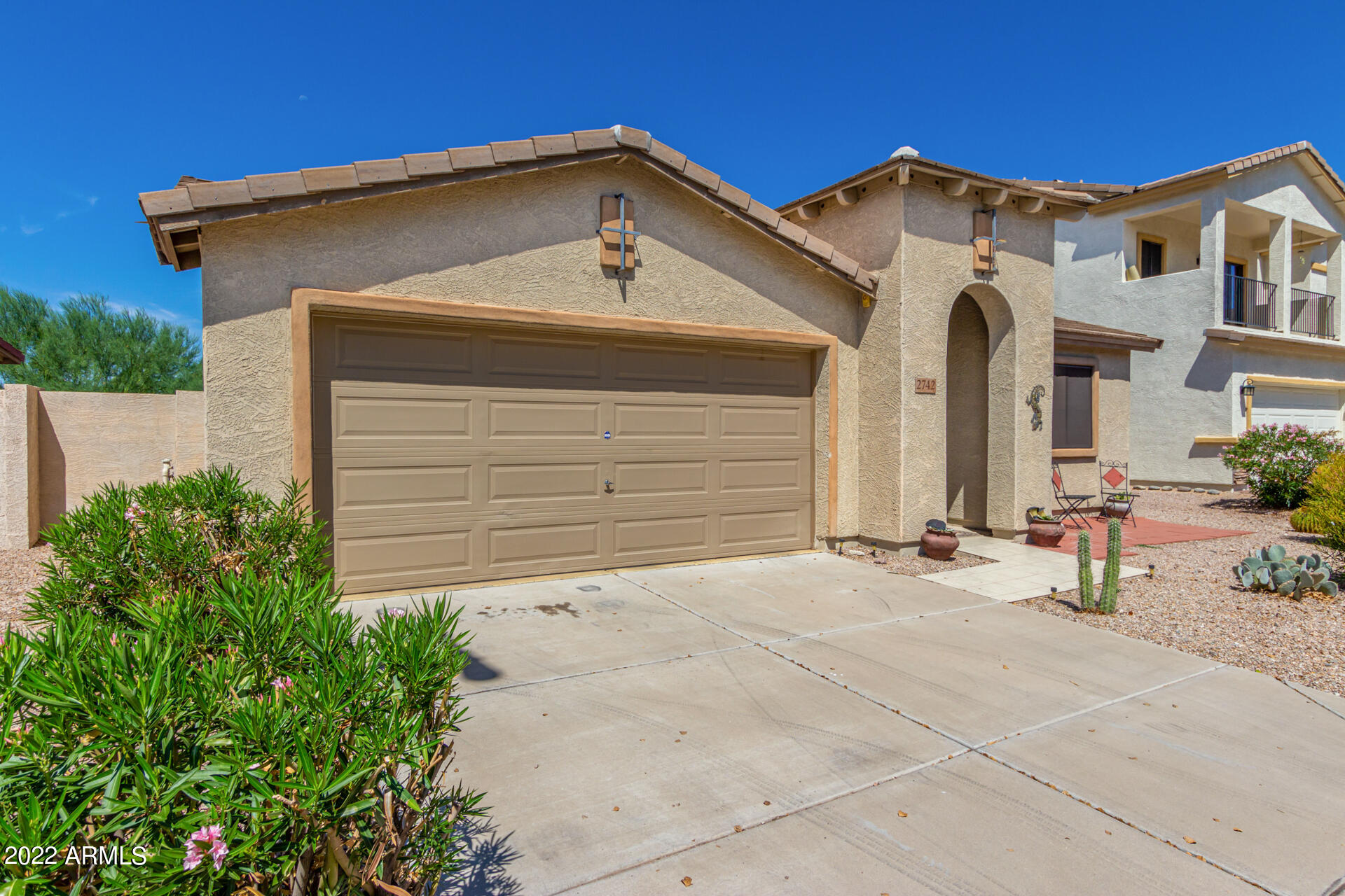 2742 South Powell Road Apache Junction, AZ 85119 - Photo 2 of 34 a front view of a house with a yard and garage