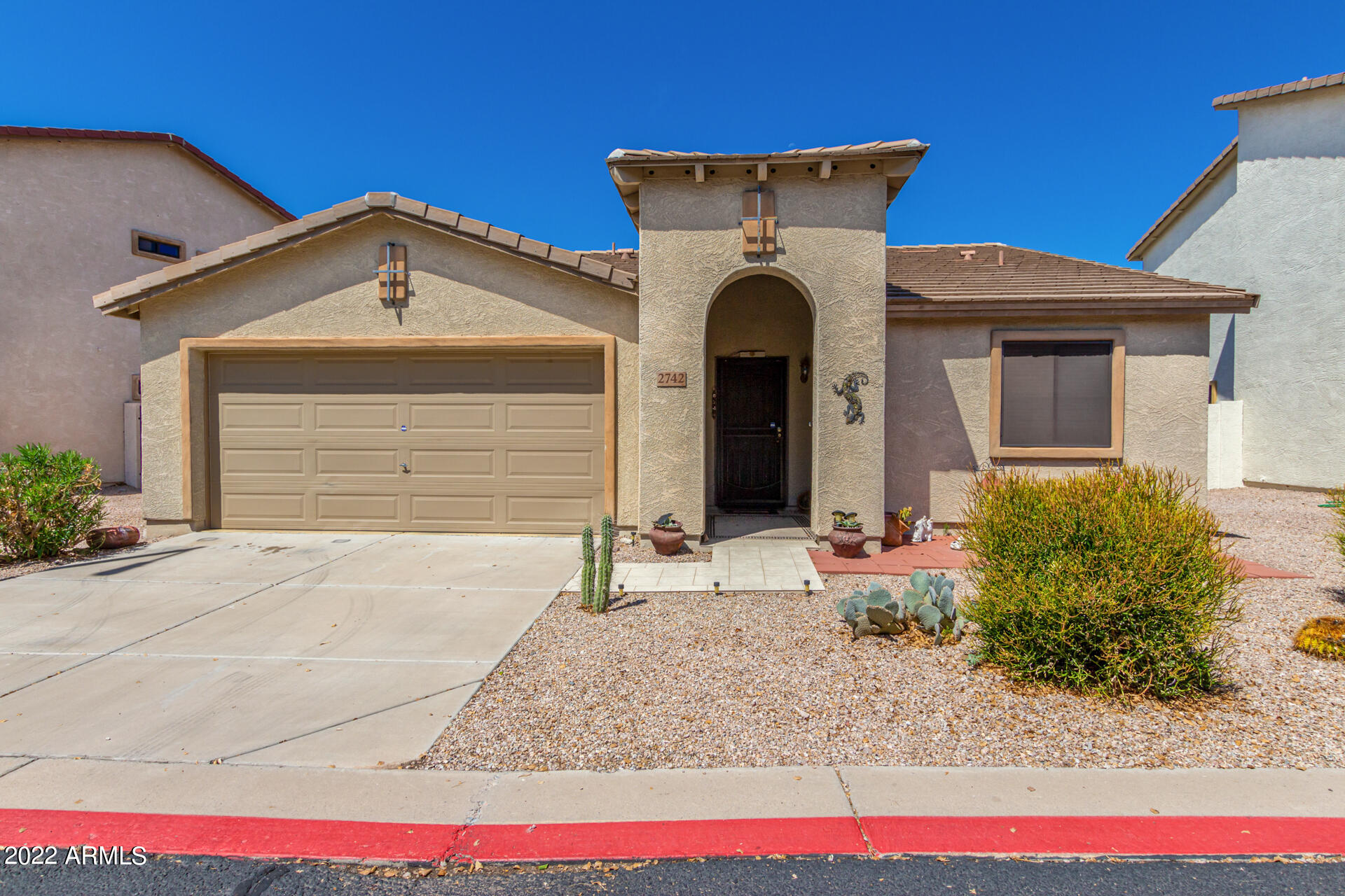 2742 South Powell Road Apache Junction, AZ 85119 - Photo 3 of 34 a front view of a house with garage