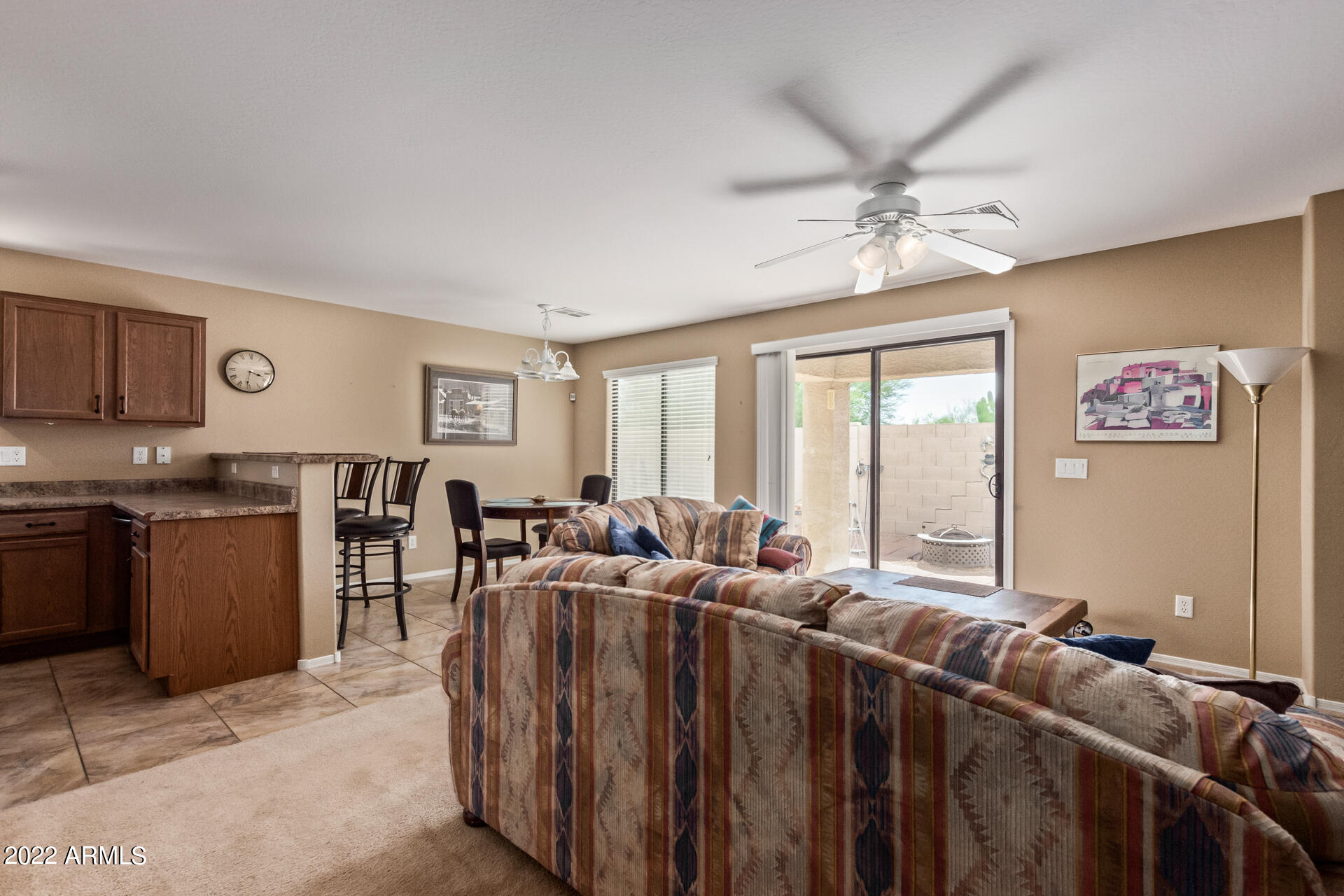 2742 South Powell Road Apache Junction, AZ 85119 - Photo 9 of 34 a living room with furniture a ceiling fan and a window