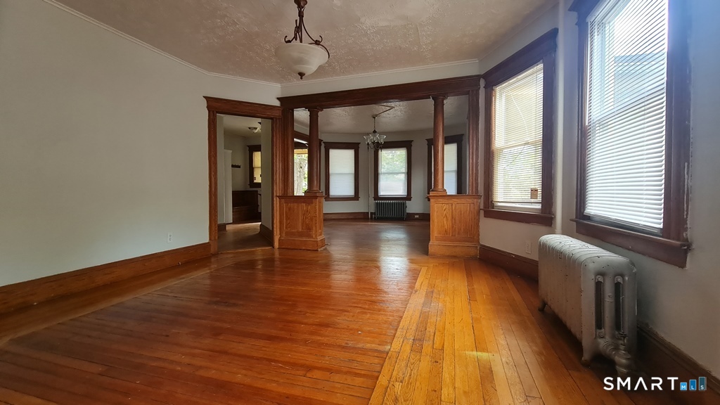 64-66 Ridge Street Manchester, CT 06040 - Photo 12 of 21 wooden floor in an empty room with a window