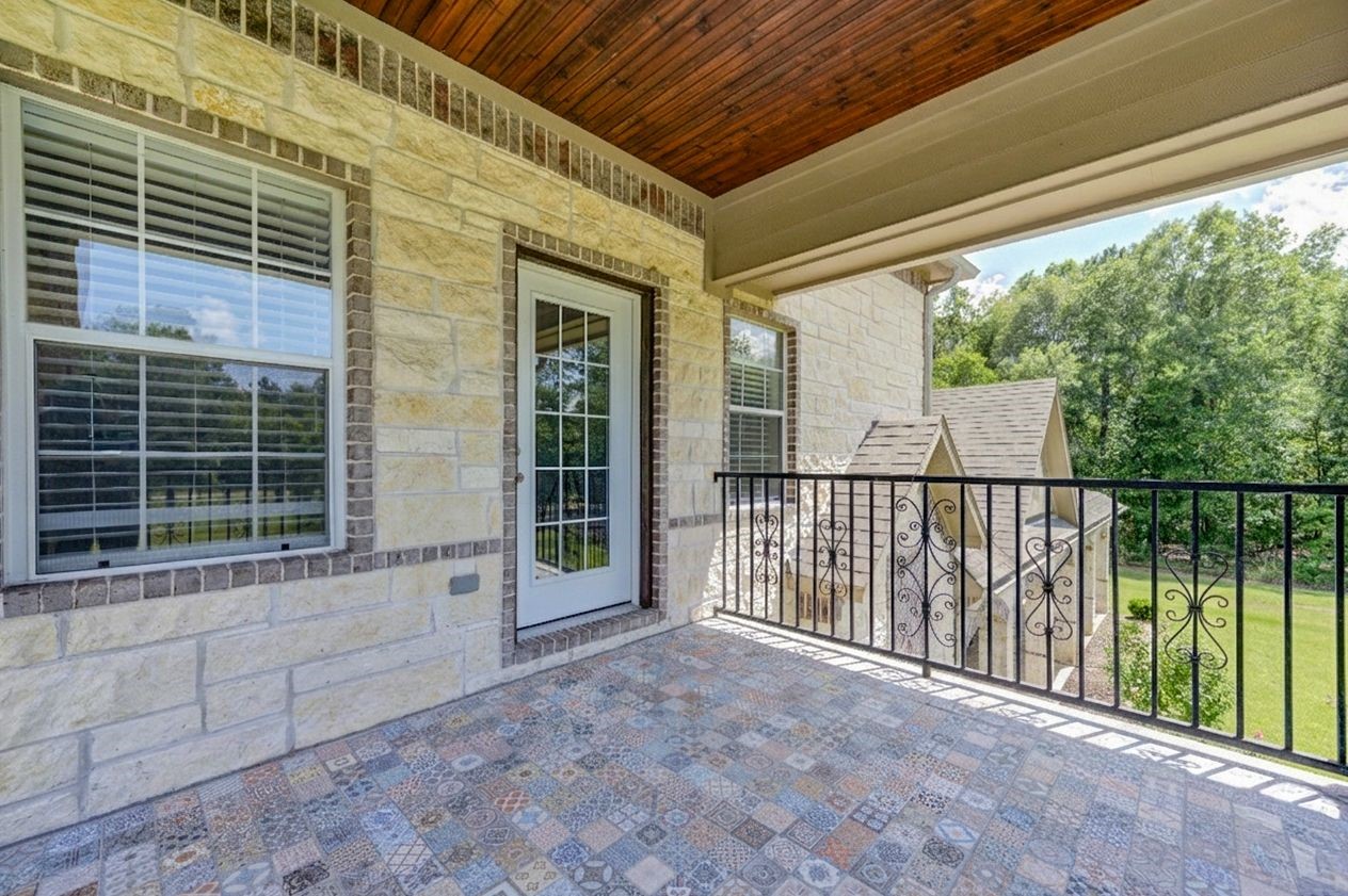 21038 Angus Drive Cleveland, TX 77328 - Photo 29 of 49 a view of a house with porch and wooden floor