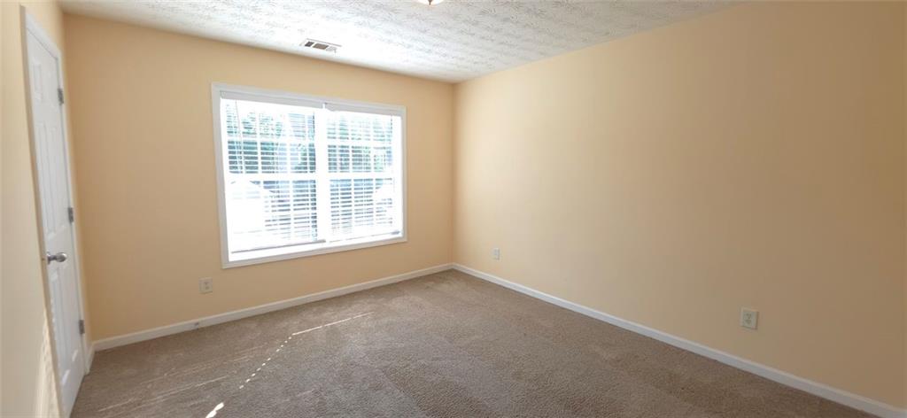 465 Little Creek Road Southeast Lawrenceville, GA 30045 - Photo 11 of 13 a view of an empty room with a window