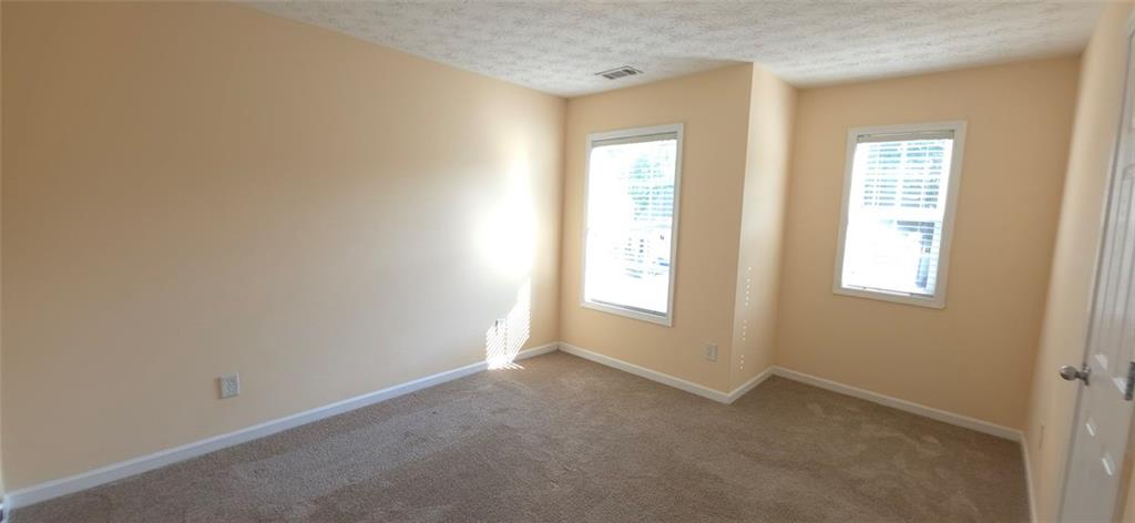 465 Little Creek Road Southeast Lawrenceville, GA 30045 - Photo 12 of 13 a view of empty room with windows